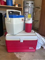 Photo showing the three coolers stacked with water heater and garage floor in background.