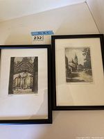Photo of two framed prints side by side showing architectural scenes with wrought iron gate and buildings