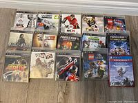 Photo showing 15 PlayStation game cases arranged in three rows, including Horizon Forbidden West for PS4 (new sealed), multiple NHL games, Minecraft editions, LEGO games, racing and adventure titles.