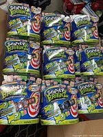 26 Scatter Brainz toy figures in original packaging, arranged showing front of packages