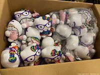 Box with 35 Hello Kitty Ty Beanie Babies plush toys, some sealed in clear bags.