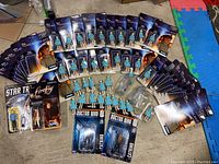 Overview of 39 action figures with several Tomorrowland female character figures both loose and in packaging, Doctor Who, Star Trek and Firefly figures in packaging.