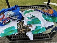 Photo showing folded men’s t-shirts with various comic and graphic designs including blue and white tees with Nemo character prints.