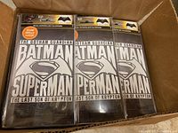 Box containing multiple sealed packs of Batman Superman glow in the dark window decals.