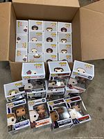 Box open showing 25 Funko Pop figures stacked inside and several outside showing character details and packaging.