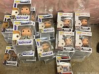 Multiple stacks of boxed Funko Pop vinyl figures including Jake Morrison, David Levinson, Jack Crawford, and Markov.