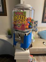 Front view of blue Beaver gumball machine filled with colorful gumballs and Bubble Brats label