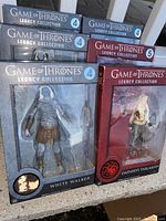 Photo showing two of the boxed Game of Thrones Legacy Collection action figures: White Walker (series 4) and Daenerys Targaryen (series 5). The boxes show some wear around edges.