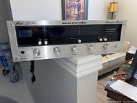 Front view of Marantz Model 2215B receiver showing brushed aluminum face, control knobs, and display