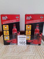 Front view of two boxed Torin Big Red 2 ton hydraulic welded bottle jacks showing product images and branding.