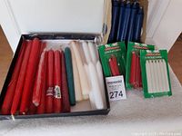 Lot of various taper and shorter candles, red, white, green, and blue colors in box and packages