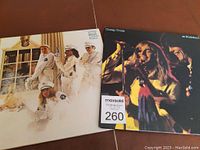 Photo of two Cheap Trick vinyl LP albums featuring Dream Police 1979 cover with band in white police uniforms and Live at Budokan 1978 cover with live stage band photo.