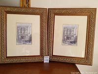Two framed prints displayed side by side on a surface showing wood frames with greenish carved accents around etched Temple of Petra images.