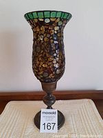 Full height view of the mosaic hurricane candle holder showing the solid brass base and mosaic glass shade.