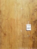 Close-up of the wooden surface showing grain, texture, and minor marks.
