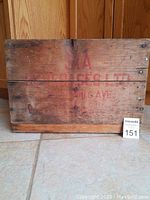 Top side of the wooden crate showing the red SIA Beverages Ltd branding and patina.
