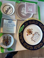 Overview of all five plates showing different sizes and designs, including boxed items and certificate for Wedgwood plates.