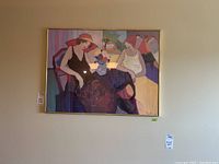 Frontal photo showing the entire framed print with the two women seated and colorful background elements.