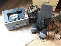 Full view of Samsung ML2240 printer, Harman Kardon HK395 speakers including subwoofer and satellite speakers, along with a basket of headphones and cables.
