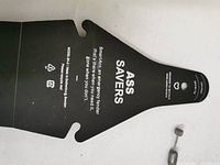 Black plastic rear mudguard with 'ASS SAVERS' branding, showing size and text.