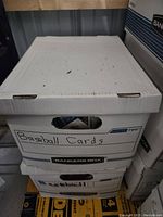 Closed white bankers box labeled 'Baseball Cards' containing baseball cards
