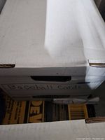 Closed white storage box labeled Baseball Cards.