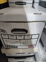 Box labeled 'Football' containing a large quantity of football cards