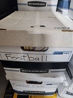 Closed bankers box marked 'Football' and 'Football Cards' containing the lot.