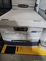 Closed banker's box labeled 'Football Cards' containing the lot of football cards.