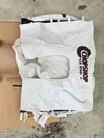 White fabric dust cover displaying the Chop Shop saw hood logo with circular saw blade graphic.