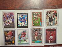 Front of 8 football cards showing players Lawrence Taylor and others in action or posed photos, some rookie cards.