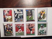 Front view of eight football cards showing players in uniform in various poses