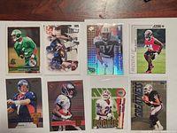 Front view of all 8 football cards showing player images and designs
