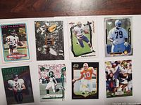 Front view of 8 football cards showing different players including Walter Payton, with trading card designs from various brands.