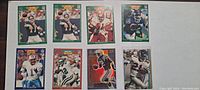 Front view of 8 football trading cards showing player photos and poses.