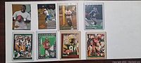 Front view of 8 football trading cards showing players in various uniforms and poses