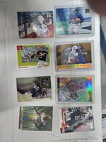 Top side of football cards arranged in two rows showing player images and team colors