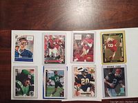 Front view of all eight football cards showing player images and rookie cards
