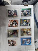 Top view of 8 football cards arranged in two rows on white surface