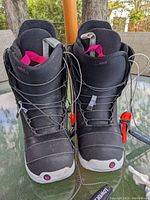 Front view of the pair of black Burton Imprint 1 snowboard boots with pink details, showing the laces and logos