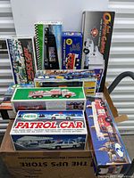 Photo showing 15-piece lot of oil company toy trucks in original boxes, including visible brands Hess, Amoco, and Texaco.