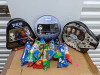 Full view of the three Star Wars PEZ dispenser sets with assorted PEZ candy packs in sealed packaging.