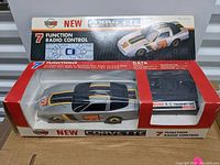 Front angle of boxed vintage remote control Corvette car showing packaging and car inside.