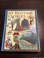 Front cover of the book showing the title '50 Bedtime Stories' with colorful illustrations of various story characters.