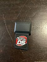 Front side of the Action Replay DS cartridge with label visible.