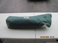 Green tent storage bag marked with UV-Tex Titanium branding.