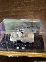 Front view of the die-cast M8 Greyhound model in display case with detailed turret and painted markings.