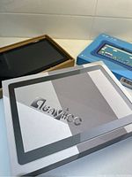 Playtronic branded tablet box partially opened showing device