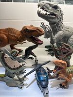 Group photo showing all dinosaur figures and the helicopter together