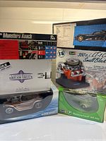 Photo showing stacked model boxes of Revell kits including Munsters Koach, Dream Truck, Beatrix Bandit, Chevrolet engine, and Messerschmitt KR 200.